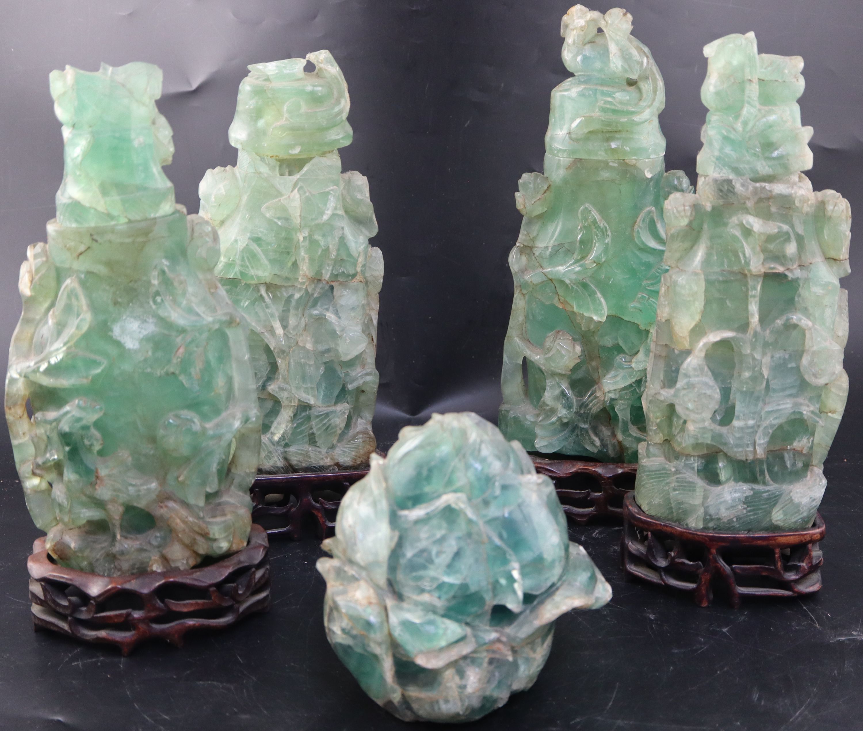 Four late 19th / early 20th century Chinese green quartz vases and covers, largest 27.5cm